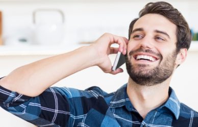 man on mobile device laughing